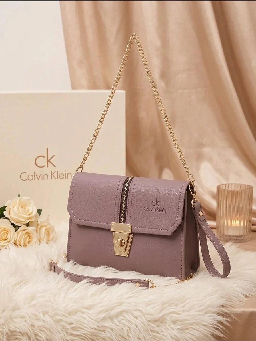 Crossbody bag with adjustable gold chain and wristlet